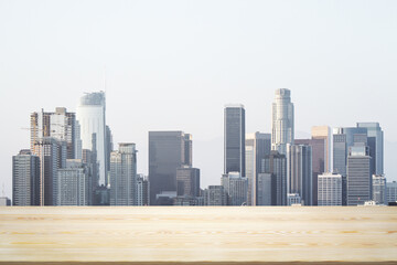 Blank table top made of wooden planks with beautiful Los Angeles cityscape at daytime on background, mockup