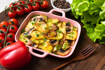 Tartiflet with bacon, herbs and vegetables at home on a wooden background. View from above.