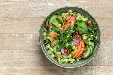 Healthy apple, celery cucumber, radish and microgreens salad