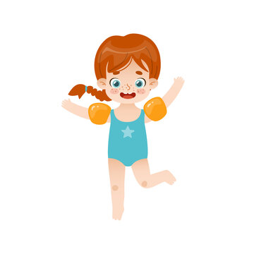 Adorable baby girl jumping with inflatable armbands. Funny red hair girl on summer vacations.