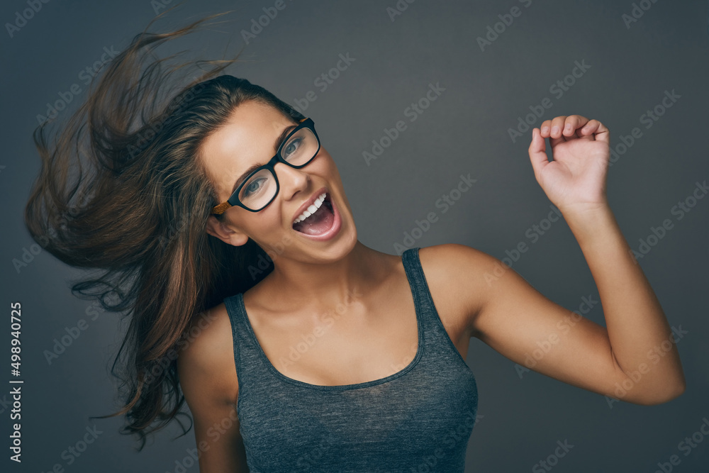 Wall mural Let go and be who you are. Studio shot of an attractive young woman wearing glasses.