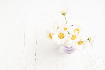 beautiful white daisy flower bouquets in a vase on wooden table