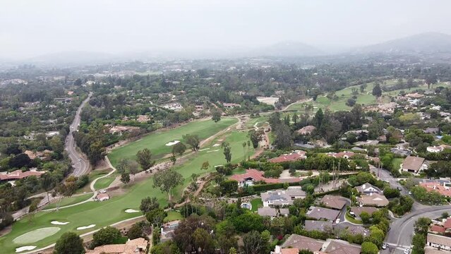An onward moving aerial shot of Rancho Santa Fe Golf Club course located at Via De La Cumbre, California, United States. It was first opened in 1929 by master golf-course architect Max Behr.