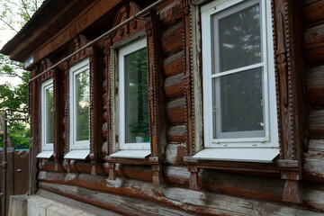 The beautiful old windows with beautifully designed platbands window on an old wooden house in the city of Tula