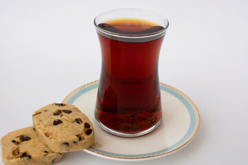Classic Turkish tea in a glass and two cookies.