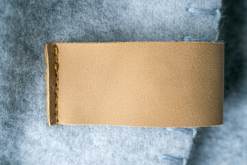 Leather blank label, brown patch on a blanket as mockup, space for text