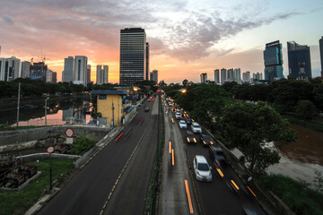 heavy traffic moving on the road in twilight, Jakarta