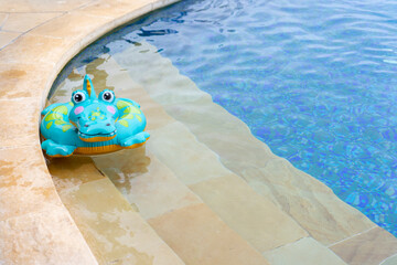 Inflatable toy crocodile in the pool