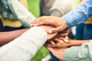 Hard times will reveal true friends. Cropped shot of a group of people joining their hands together.