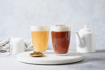 Different Cheese tea made of green tea and black tea with layer of whipped cream cheese foam topped. Close up. Asian trendy beverage.