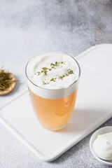 Chinese Cheese Tea with layer of creamy foam. Asian trendy beverage. Thai milk tea. Vertical format. Close up.