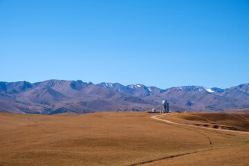 Beautiful mountains with Assy-Turgen observatory in autumn season. Space observatory research. Assy plateau in Ili-Alatau national park. Travel, tourism in Kazakhstan concept.
