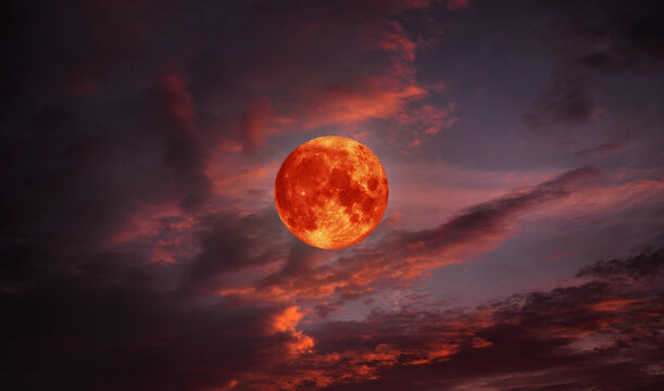 blood moon concept of a red full moon in black sky with cloud.