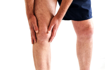 a man got injured holding on knee because of pain from overuse knee or workout isolated on white,...