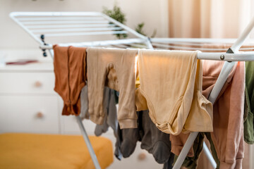 Baby's clothes, bodysuits and pants are dried after the laundry. Organization and cleaning in the children's room