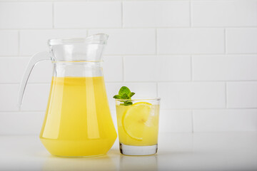 fresh lemonade in glass with lemon