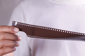 holding a camera with film rolls close up 