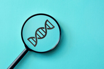 DNA through a magnifying glass. Symbol of research and diagnosis of genetic diseases