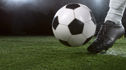Fototapeta na wymiar Close-up of Football Player Kicking Soccer Ball