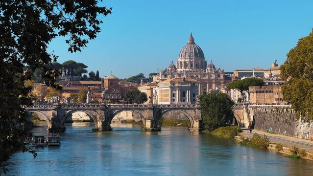 Wide shot of River, Ponte Vittorio Emanuele II Bridge and St. Peter's Basilica of Vatican in background
