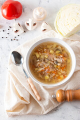 Shchi soup with cabbage is a traditional dish of Russian cuisine on a white background. View from above.