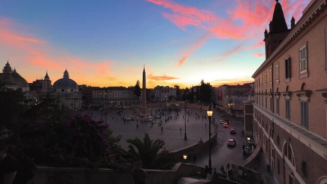 Dolly shot showing traffic and many tourist at Piazza del Popolo in Rome during sunset