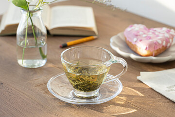 a cup of green tea on wood board.