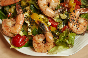 large fried shrimp with tomatoes and vegetables. salad with shrimp and seafood