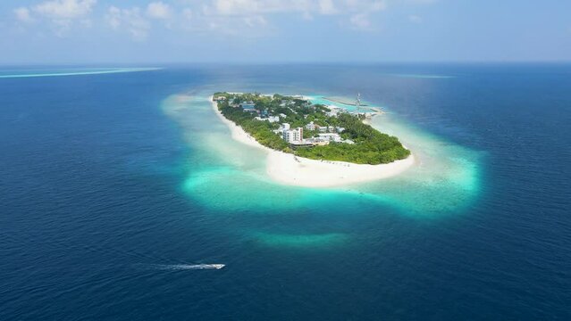 Tropical island in Maldives with white sand beach and turquoise sea water. Touristic vacation holidays travel destination. Scenic landscape. Drone aerial video footage. Ukulhas, North Ari Atoll.