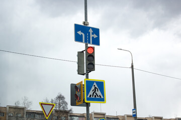 Red signal traffic light on blue sky background