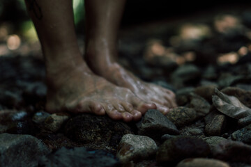 p&eacute;s descal&ccedil;os sobre pedras do rio