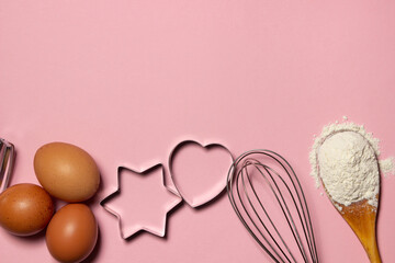 Baking ingredients on a pink background. Molds for making shortbread cookies. There is space for text or logo