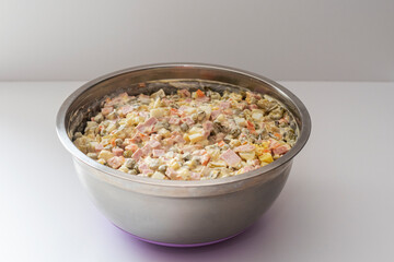 Olivier salad - a classic recipe with mayonnaise, an incredible taste. olivier salad on a white on a white background, homemade recipe.