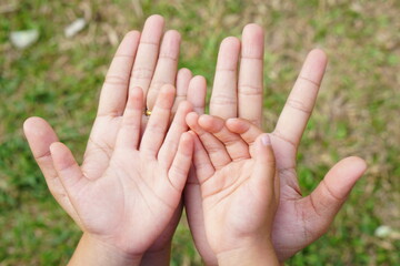 Mother and Child’s holding hands to receive something