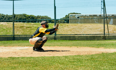 Hes ready to get a good catch. Full length shot of a young baseball player preparing to catch a ball during a match on the field.