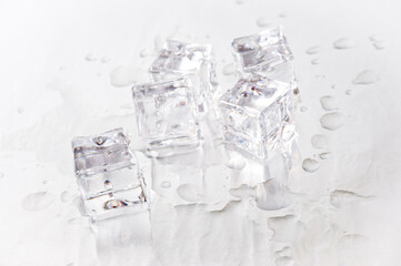 Clear ice cubes for cooling drinks on a light background.