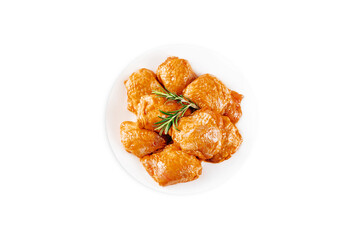 Marinated chicken thighs in red sauce on isolated white background.Top view.Copy space.Semifinished. Fast cooking.Raw marinated chicken meat.
