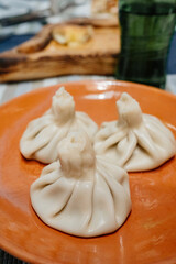 Khinkali on a clay plate. a traditional dish of Georgian cuisine.