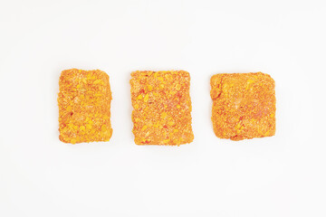 Fast food, food at home.Frozen breaded nuggets fillet pieces on an isolated background.Breaded chicken nuggets.Semifinished. Fast cooking.