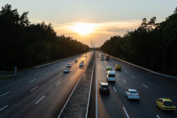 Traffic on highway at sunset