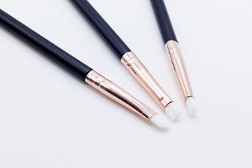 three pieces of makeup brushes on white background