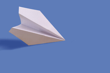 Paper airplane on a blue paper background