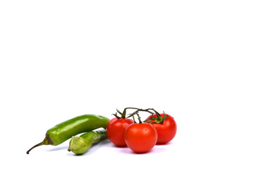 Green pepper and red tomatos isolated on white background.