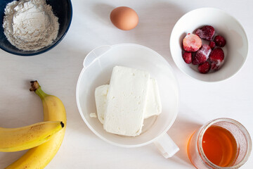 Ingredients for making cottage cheese casserole with bananas and strawberry