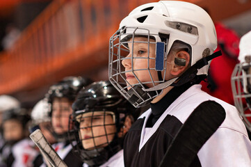 Little hockey player watching the game