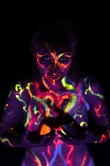 naked girl with her skin painted with ultraviolet paint
