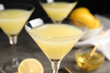 Delicious bee's knees cocktail on grey table, closeup