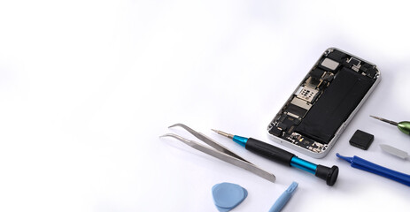 Technician repairing the smartphone's motherboard in the lab with copy space. the concept of...