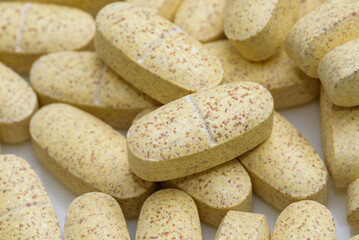 Oval-shaped supplement tablets (Yellow color)