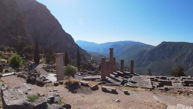 Panoramic sweep into the heart of the mythological and archaeological site of Delphi. In the most important and prominent position, the temple of Apollo.